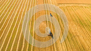 Harvester working in field and mows wheat. Ukraine. Aerial view.