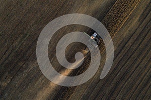 Harvester working in field and mows wheat. Ukraine. Aerial view.