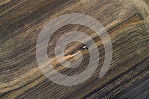 Harvester working in field and mows wheat. Ukraine. Aerial view.