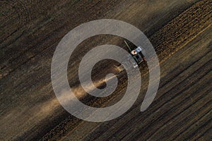 Harvester working in field and mows wheat. Ukraine. Aerial view.