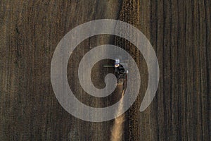 Harvester working in field and mows wheat. Ukraine. Aerial view.