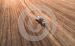 Harvester working in field and mows wheat. Ukraine. Aerial view.