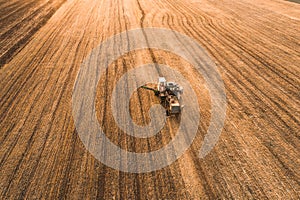 Harvester working in field and mows wheat. Ukraine. Aerial view.