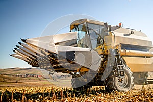 Harvester working in the fields. Farmer using combine machinery, industrial agriculture