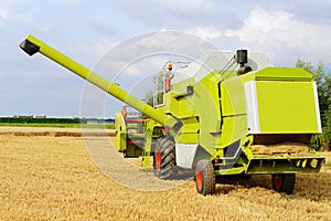 Harvesting combine on farmland
