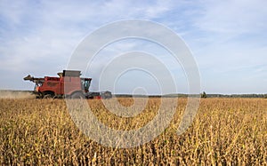 Harvesting combine in the wheat photo