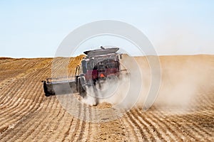 harvesting crops on palouse washington wheat fields in summer