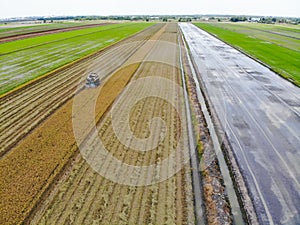 Harvesting farm, Harvester machinery in field.