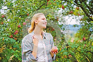 Harvesting season concept. Woman hold apple garden background. Farm produce organic natural product. Girl rustic style