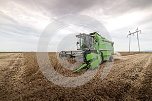 Agricultural machine harvesting soybean field