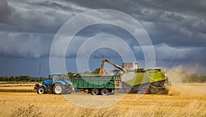 Harvesting under a very stormy looking sky.