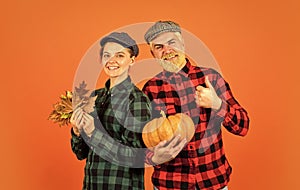 Harvesting vegetables. colors of fall season. Harvest time concept. happy family of farmers. man and woman retro peaked