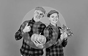 Harvesting vegetables. colors of fall season. Harvest time concept. happy family of farmers. man and woman retro peaked