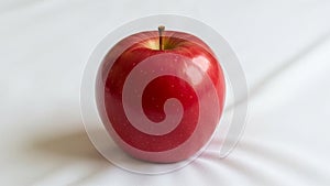 Has a glossy surface with small white specks and a slightly visible stem