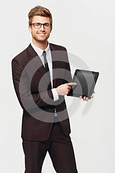 This has great resolution. Studio portrait of a stylishly-dressed young businessman pointing to a digital tablet hes