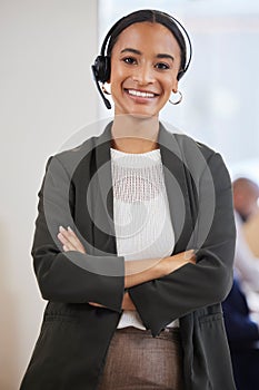 She really has a knack for the sales game. Portrait of a confident young businesswoman standing with her arms crossed in