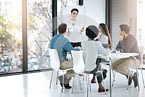 She has a plan from start to finish. a businesswoman giving a presentation to her colleagues in a modern office.