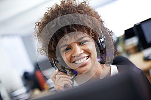 She always has a smile for clients. Portrait of an attractive young female call center operator.