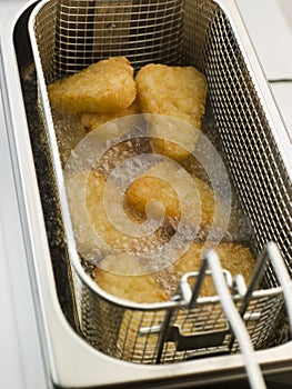 Hash Browns being Deep Fried in Corn Oil