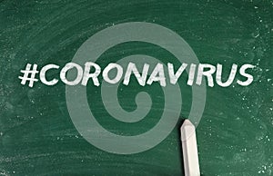 Hashtag Coronavirus and piece of white chalk on greenboard, top view