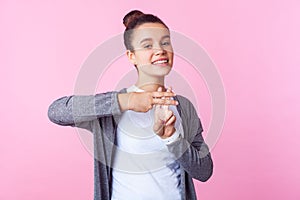Hashtag, internet popularity. Portrait of cheerful trendy teenage girl showing hash symbol. pink background