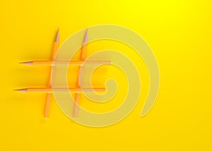 Hashtag sign made of pencil on yellow background with copy space