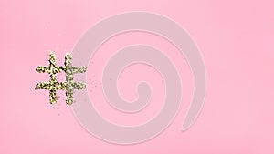 Hashtag from sparkles on a pink background. Online technology concept, creativity, artist, beauty, social media