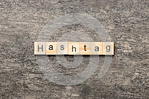 hashtag word written on wood block. hashtag text on table, concept