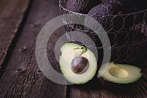 Hass avocado in a basket on a wooden table