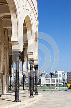 Hassan II Mosque pillars surrounded by modern residential buildings in Casablanca, Morocco