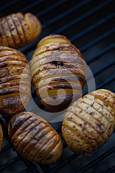 Hasselback potatoes on a bbq rack.