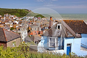 HASTINGS, UK: General view of Hastings old town from West Hill with green hills and the sea in the background