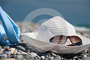 Hat, bag, and glasses on beach