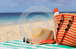 Hat, bag, sun glasses and flip flops on the beach