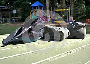 Hat and boots with children playing on rides in park