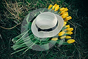 Hat on a bouquet of spring tulips. Spring mood. Spring has come.