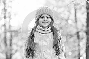 Hat keep warm. Kid wear warm soft knitted hat. Warm woolen accessory. Girl long hair happy face nature background. Keep