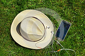 Hat with mobile phone and headphones.