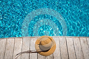 Hat at the side of swimming pool, summer travel concept