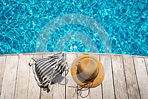 Hat at the side of swimming pool, summer travel concept