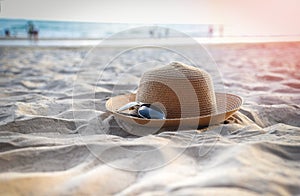 Hat summer - straw hat fasion and sunglasses accessories on sandy beach sea background