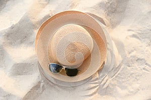 hat summer - straw hat fasion and sunglasses accessories on sandy beach sea background top view photo