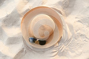 hat summer - straw hat fasion and sunglasses accessories on sandy beach sea background top view