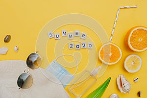 Hat, sunglasses,medical protective mask, spray, shells, citrus fruits and straw tubes, lettering summer 2020 in square wooden