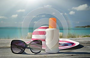 Hat, sunglasses and sun lotion