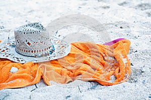 Hat and towel on a beach