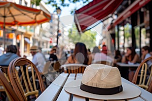 hat under an outdoor restaurant table with diners and city street view