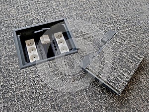 hatch in the floor hides the slots for connecting to the mains and