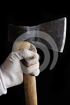 Hatchet ax in hand isolated on black background