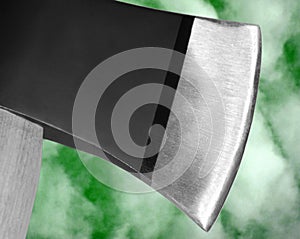 Hatchet / axe head on green photo